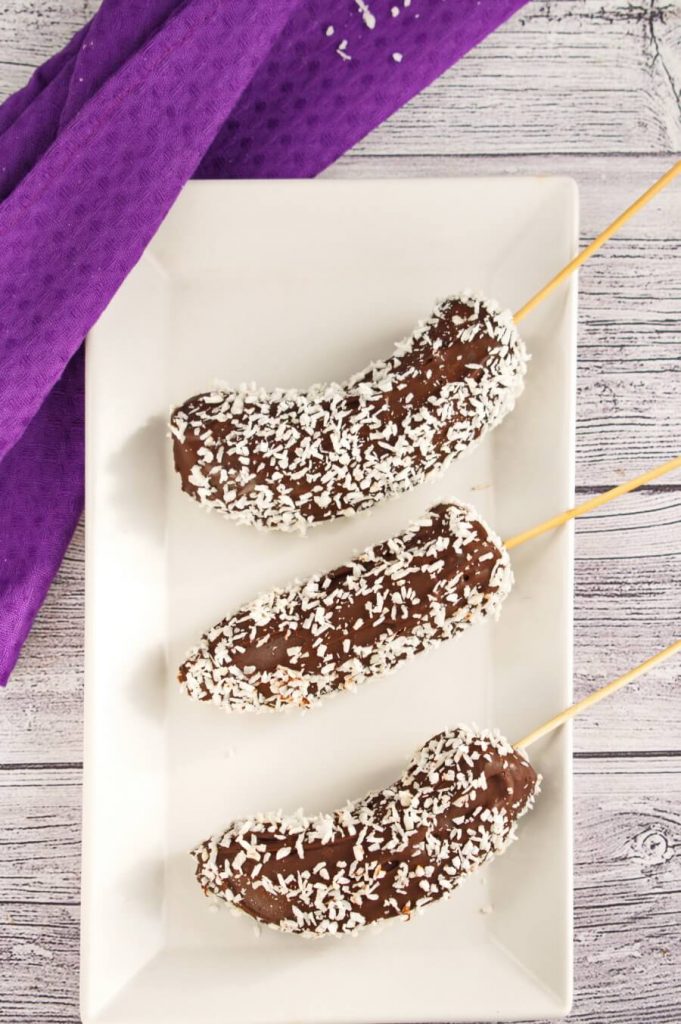A frozen banana popsicle coated in chocolate