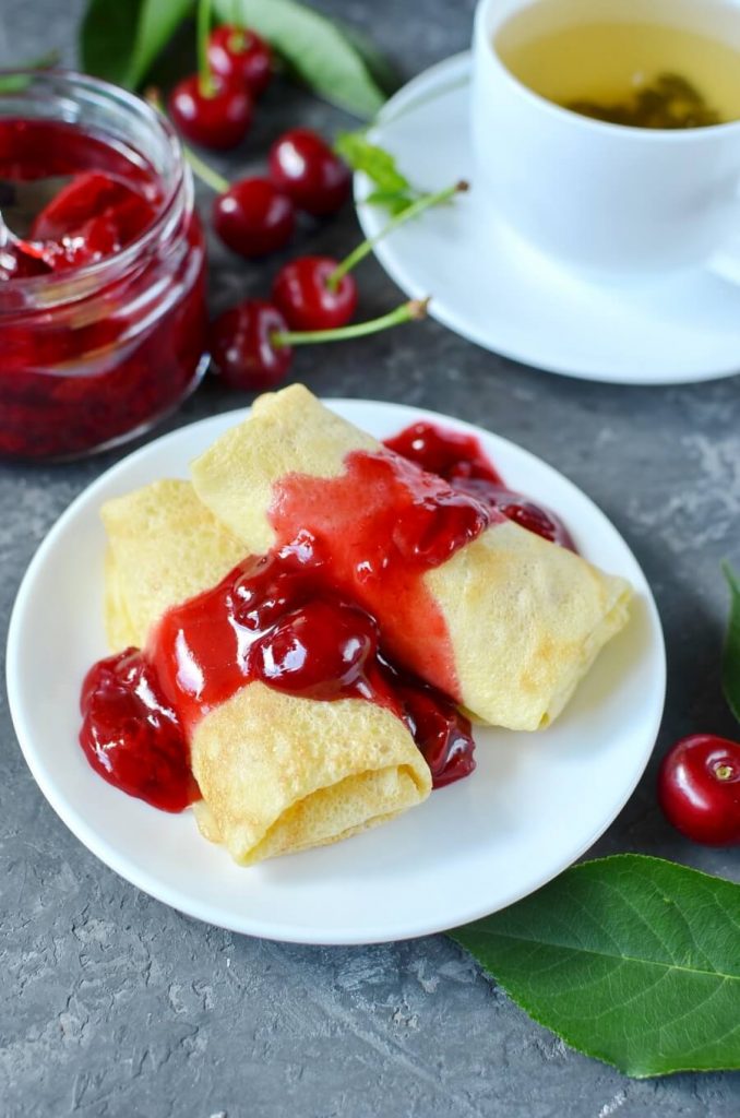 Sweet Cream Cheese Stuffed Crepes with a Cherry Syrup